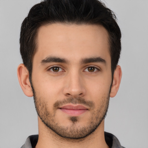 Joyful white young-adult male with short  brown hair and brown eyes