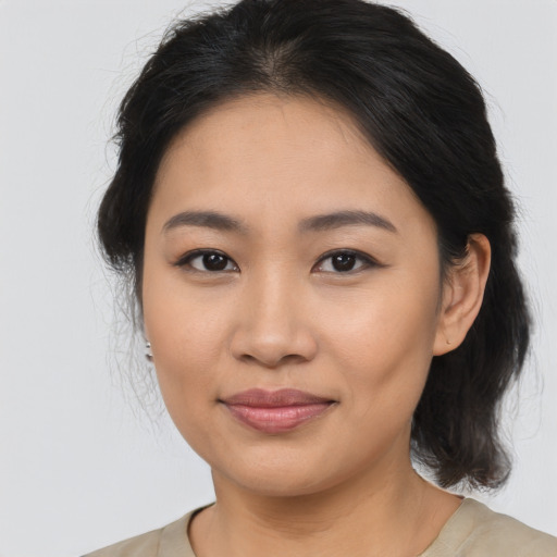 Joyful asian young-adult female with medium  brown hair and brown eyes