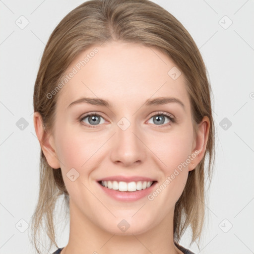 Joyful white young-adult female with medium  brown hair and blue eyes