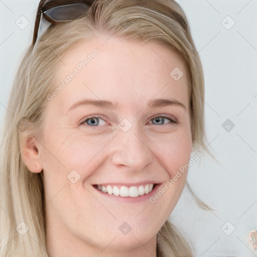 Joyful white young-adult female with long  blond hair and blue eyes