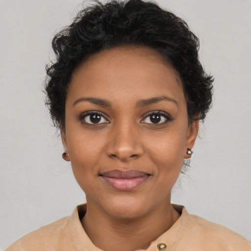 Joyful black young-adult female with short  brown hair and brown eyes