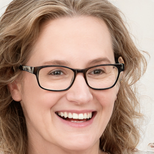 Joyful white adult female with long  brown hair and blue eyes