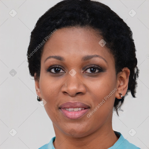 Joyful black adult female with short  black hair and brown eyes