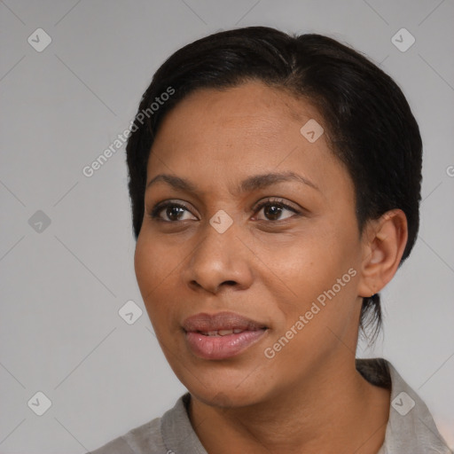 Joyful black young-adult female with short  black hair and brown eyes