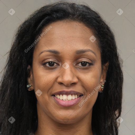 Joyful black adult female with long  brown hair and brown eyes