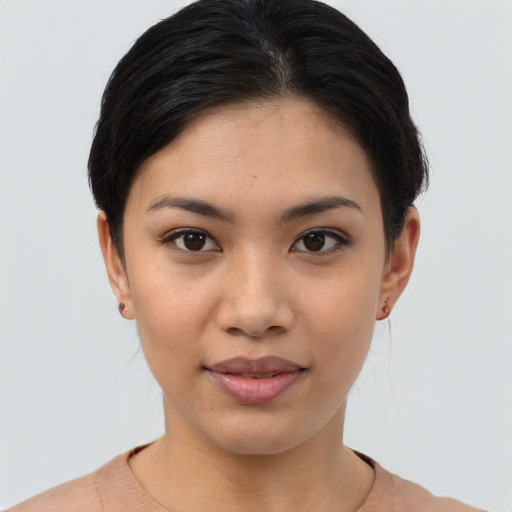 Joyful asian young-adult female with short  brown hair and brown eyes