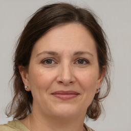 Joyful white adult female with medium  brown hair and brown eyes