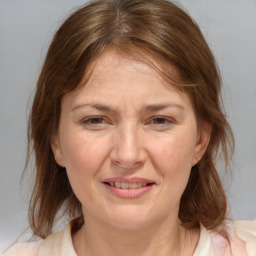 Joyful white adult female with medium  brown hair and grey eyes