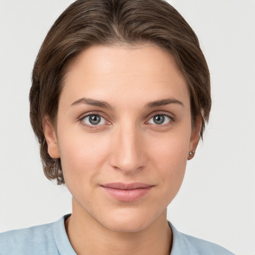 Joyful white young-adult female with short  brown hair and grey eyes