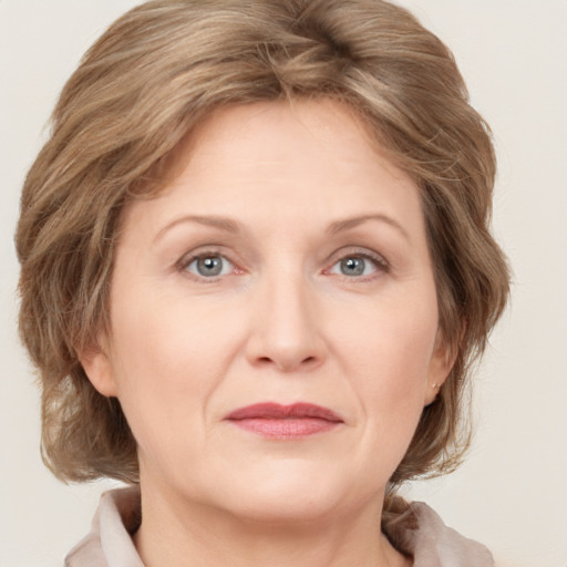 Joyful white adult female with medium  brown hair and grey eyes