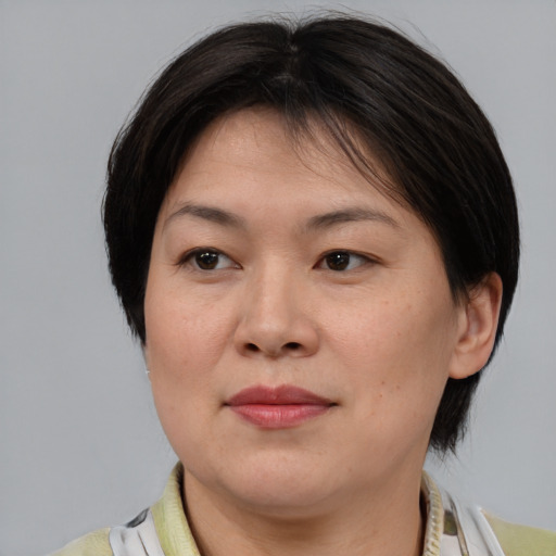 Joyful asian adult female with medium  brown hair and brown eyes