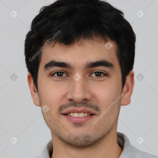 Joyful latino young-adult male with short  brown hair and brown eyes