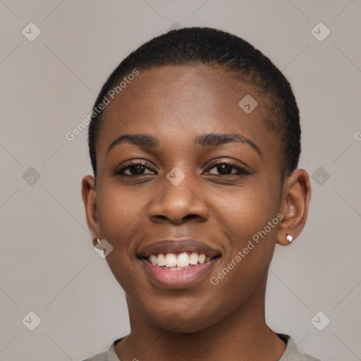 Joyful black young-adult female with short  black hair and brown eyes