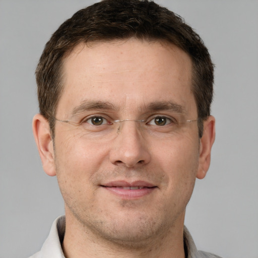 Joyful white adult male with short  brown hair and brown eyes