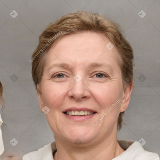 Joyful white adult female with medium  brown hair and blue eyes