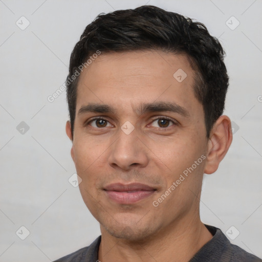 Joyful white young-adult male with short  black hair and brown eyes