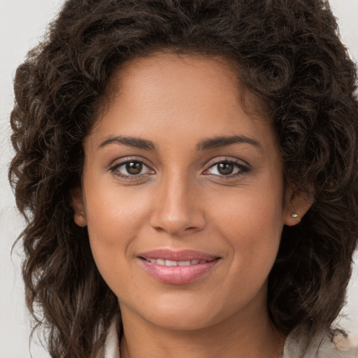 Joyful white young-adult female with long  brown hair and brown eyes