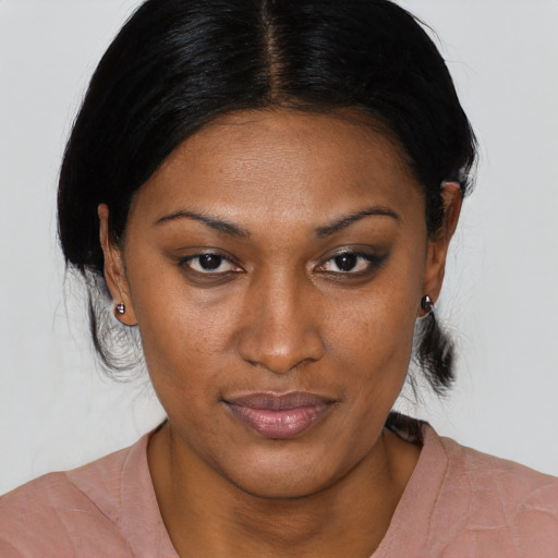 Joyful black young-adult female with short  brown hair and brown eyes