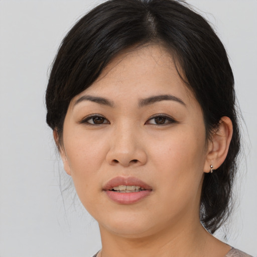 Joyful asian young-adult female with medium  brown hair and brown eyes