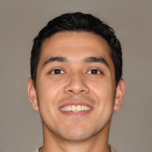 Joyful white young-adult male with short  black hair and brown eyes