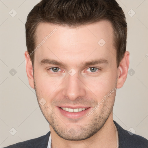 Joyful white young-adult male with short  brown hair and grey eyes