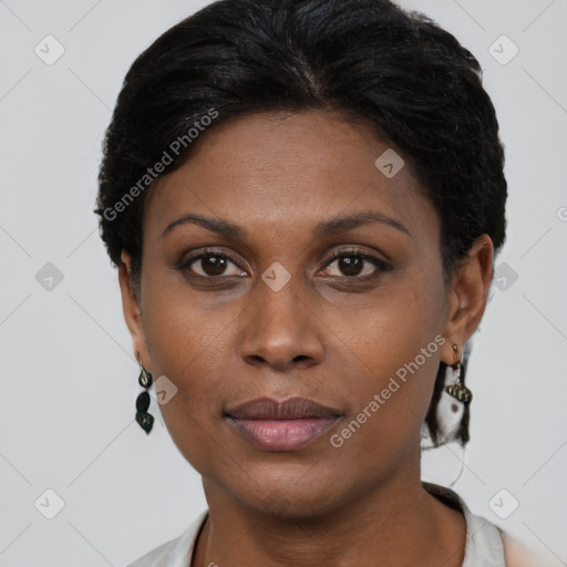 Joyful black young-adult female with short  brown hair and brown eyes