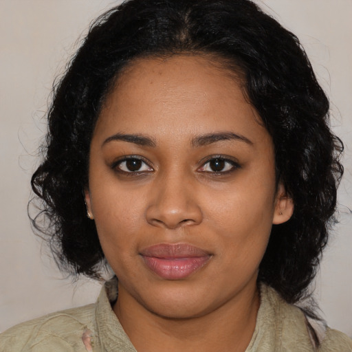 Joyful black young-adult female with medium  black hair and brown eyes