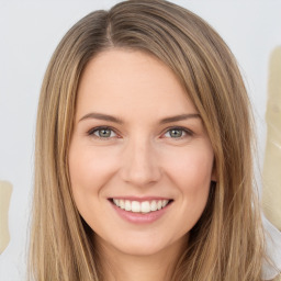 Joyful white young-adult female with long  brown hair and green eyes