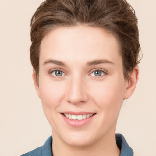 Joyful white young-adult female with short  brown hair and grey eyes