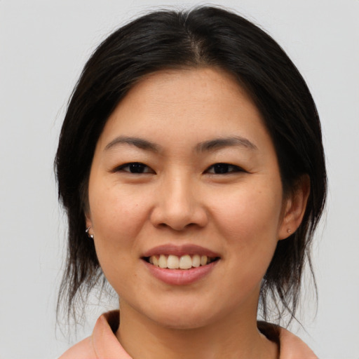 Joyful asian young-adult female with medium  brown hair and brown eyes
