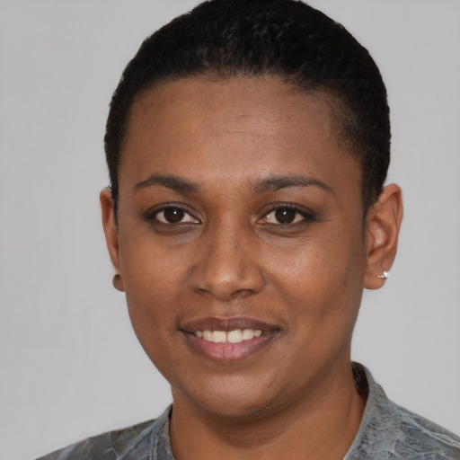 Joyful black young-adult female with short  black hair and brown eyes