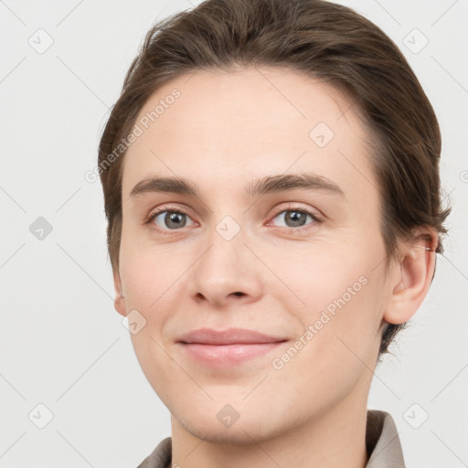 Joyful white young-adult female with short  brown hair and grey eyes