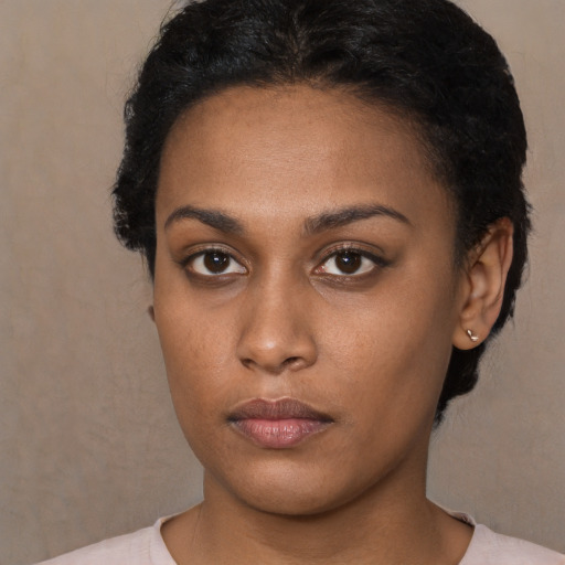Neutral black young-adult female with medium  brown hair and brown eyes