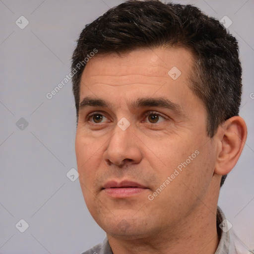 Joyful white adult male with short  brown hair and brown eyes