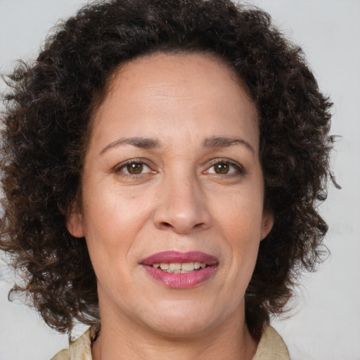 Joyful black adult female with medium  brown hair and brown eyes