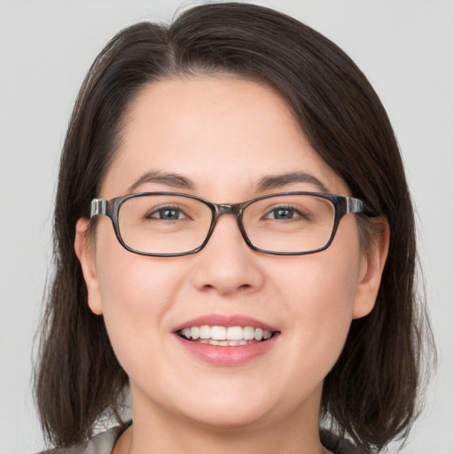 Joyful white young-adult female with medium  brown hair and brown eyes