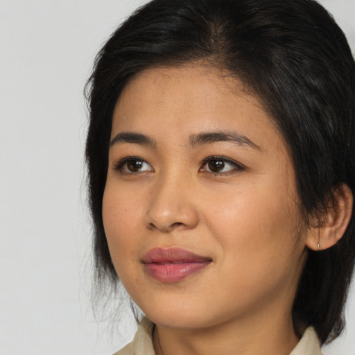 Joyful asian young-adult female with medium  brown hair and brown eyes