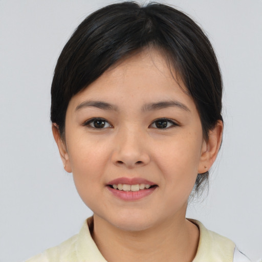 Joyful asian young-adult female with medium  brown hair and brown eyes