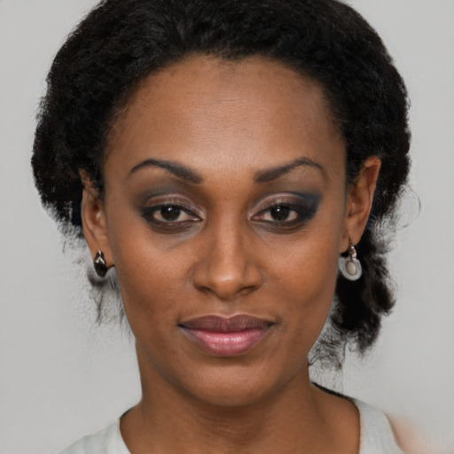 Joyful black young-adult female with medium  black hair and brown eyes