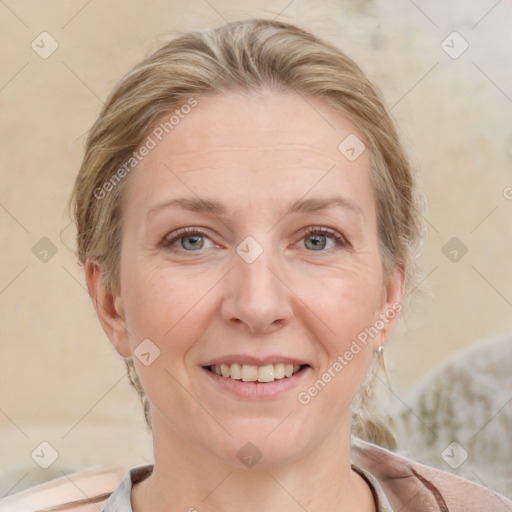 Joyful white adult female with medium  brown hair and blue eyes