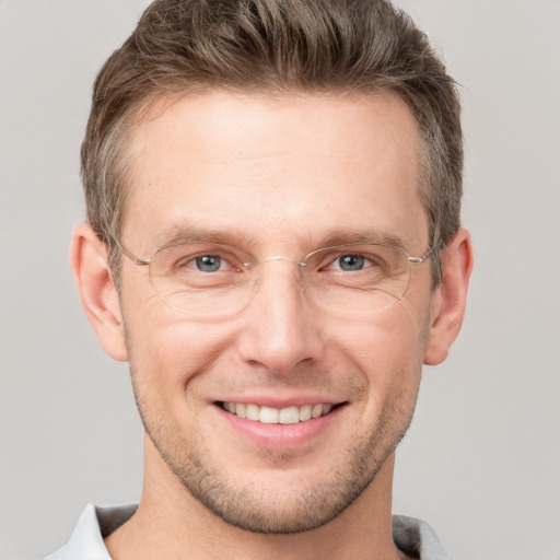 Joyful white adult male with short  brown hair and grey eyes