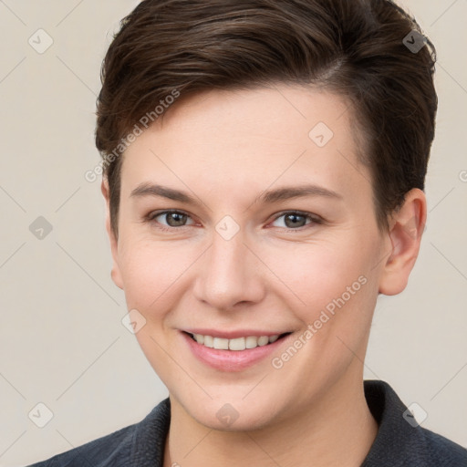 Joyful white young-adult female with short  brown hair and grey eyes