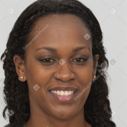 Joyful black young-adult female with long  brown hair and brown eyes