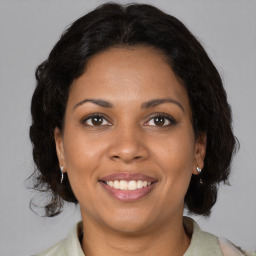 Joyful black adult female with medium  brown hair and brown eyes