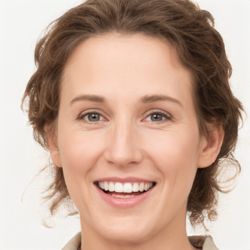 Joyful white young-adult female with medium  brown hair and green eyes