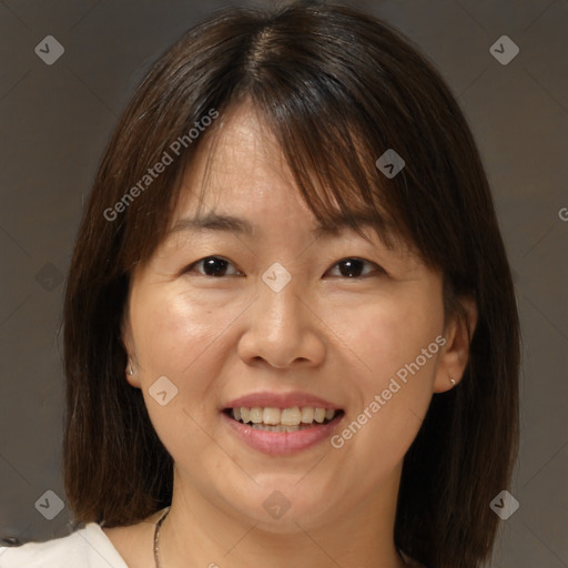 Joyful white adult female with medium  brown hair and brown eyes