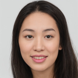 Joyful asian young-adult female with long  brown hair and brown eyes