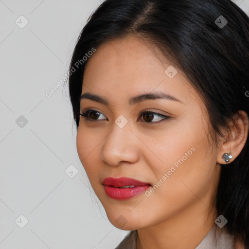 Joyful latino young-adult female with medium  brown hair and brown eyes