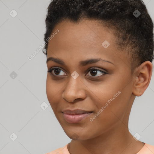 Joyful black young-adult female with short  brown hair and brown eyes