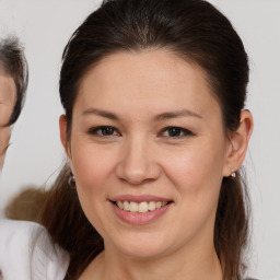 Joyful white young-adult female with medium  brown hair and brown eyes